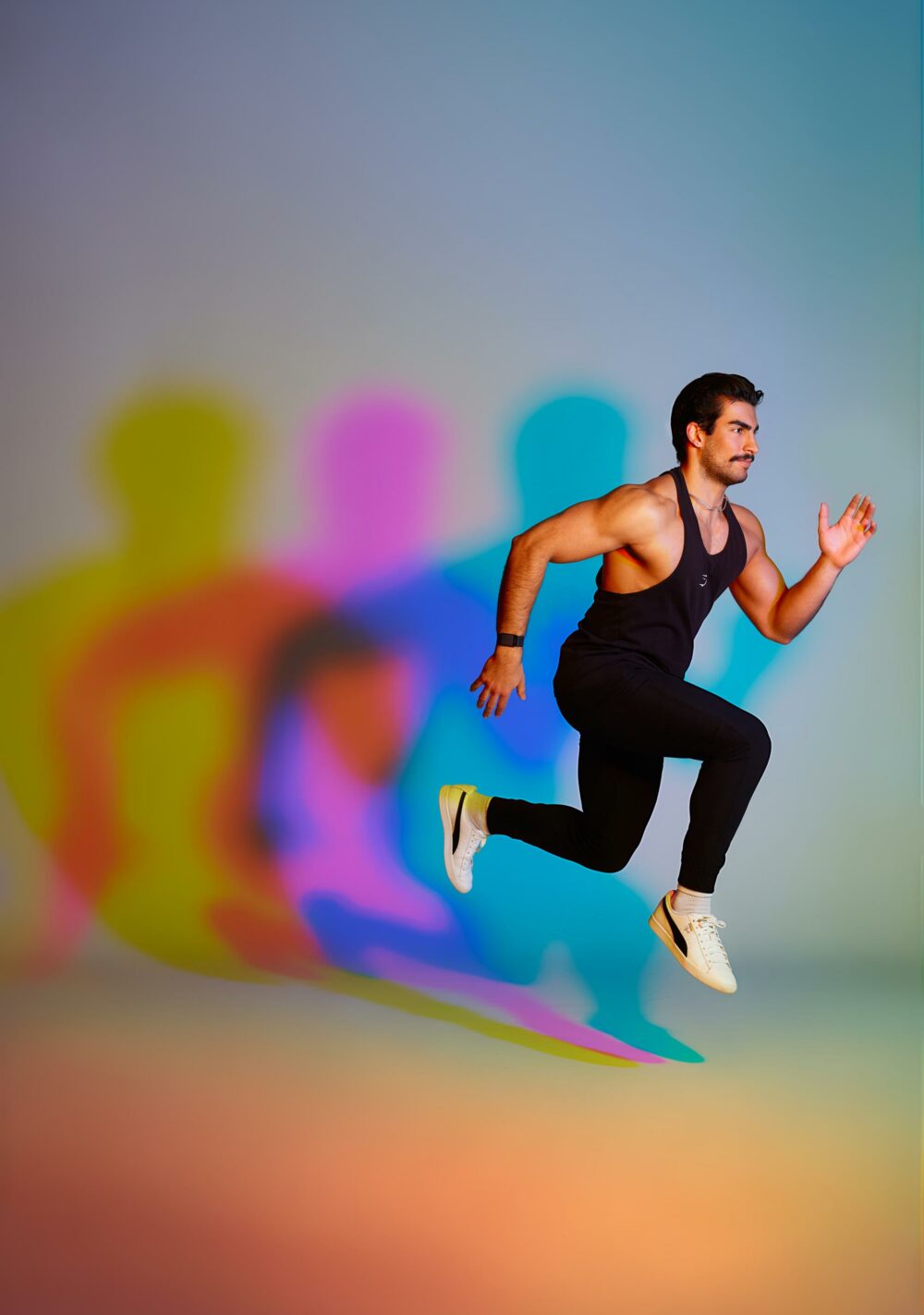 male model jumping, with colored shadow in the background