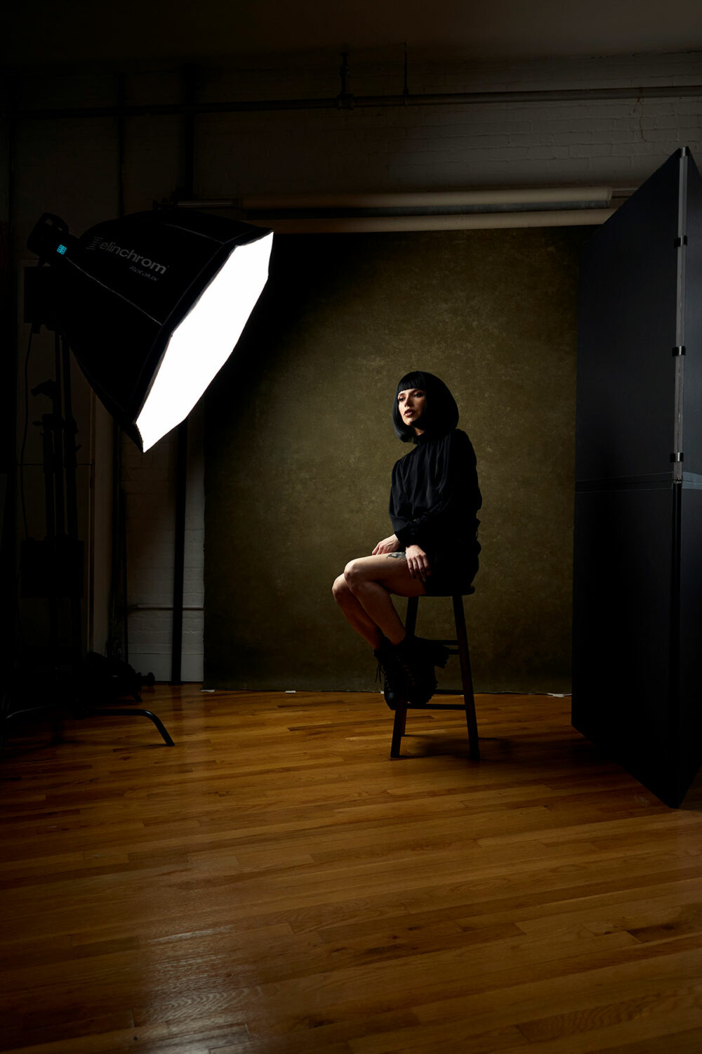 Female model posing in a studio with a low key light created by the Rotalux Softbox Deep Octa