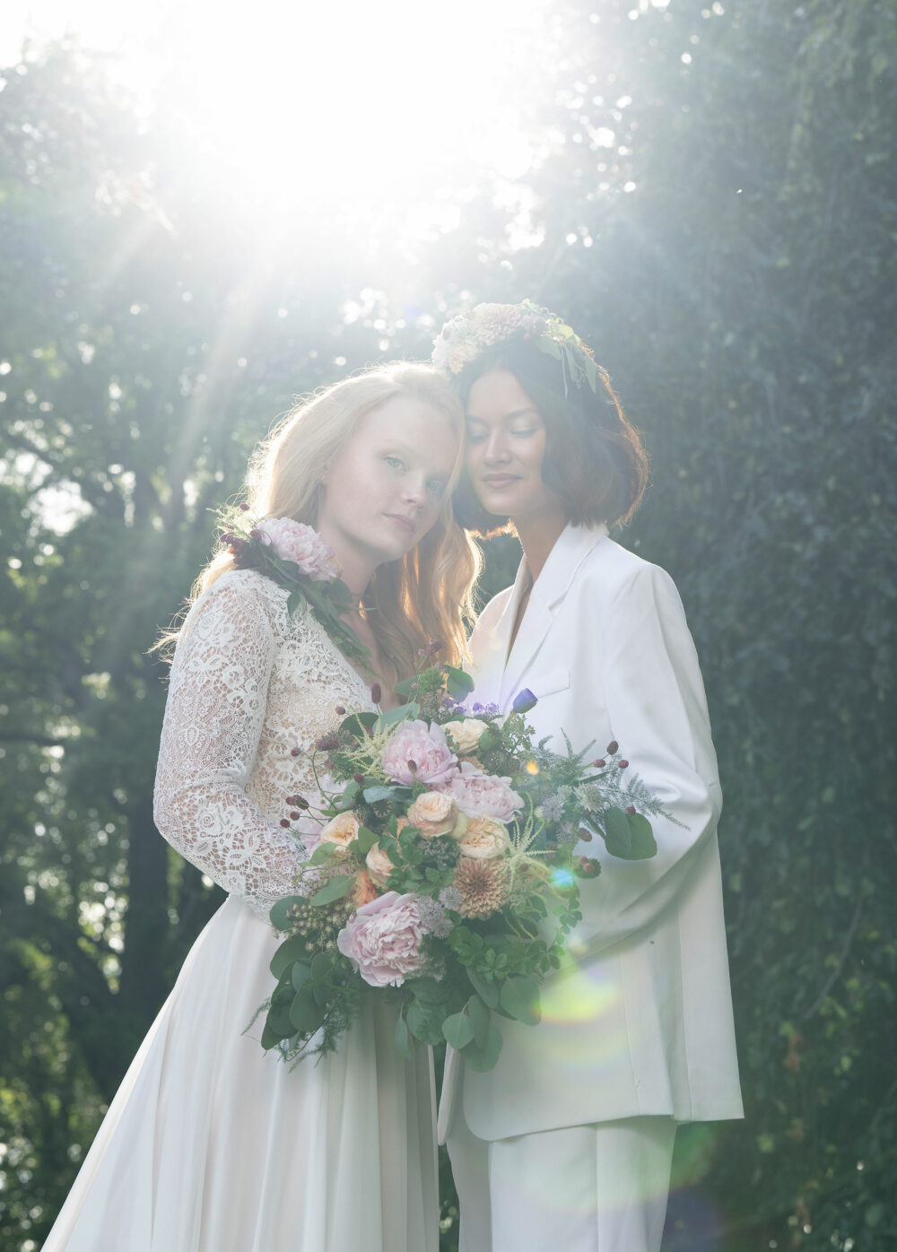 Female couple posing with the sun as backlight