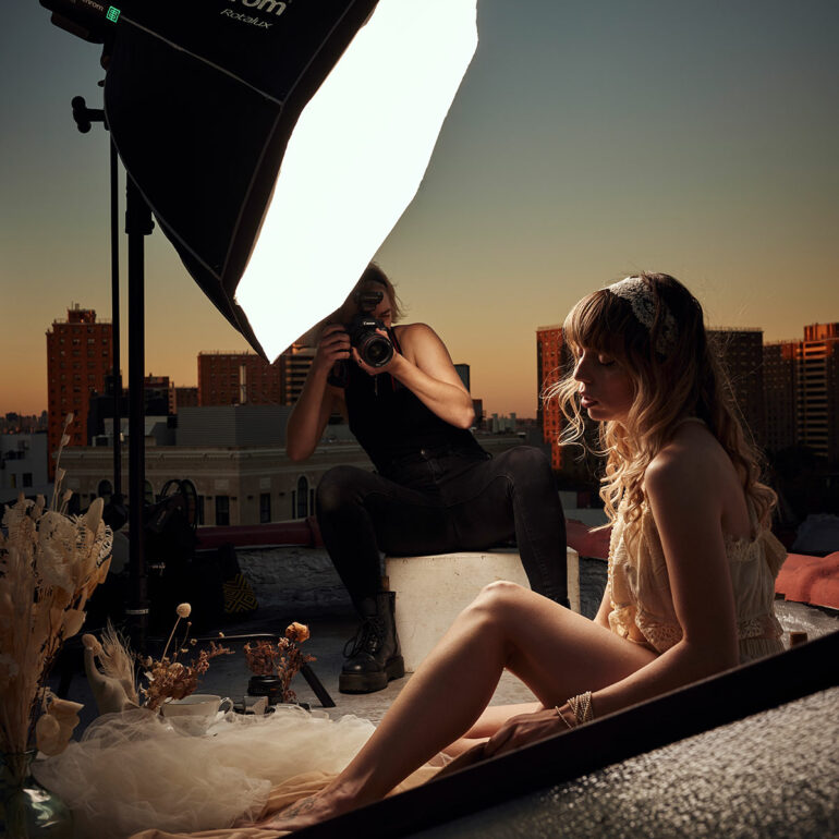 Behind the scene of a photoshoot showing battery monolight Elinchrom FIVE with a Rotalux, female model and photographer Emily Teague
