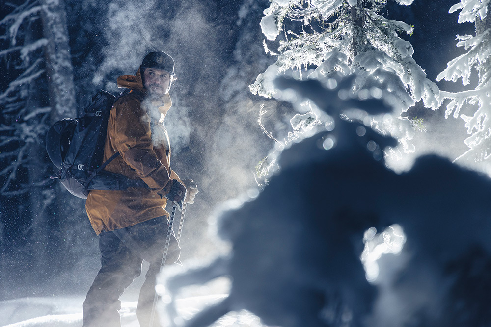 Man surrounded by snow and trees