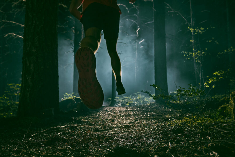 Photo of legs running in wood